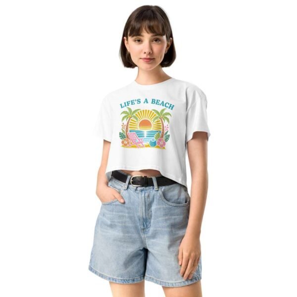 Woman wearing beach life crop top with vibrant tropical sunset, florals, and beach chair